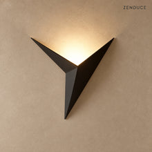 EZIA black geometric LED wall light on mushroom taupe with natural shadow