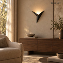 EZIA black wall sconce above a walnut living room console