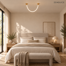 FENNA compact gold single-tube chandelier in a softly styled bedroom