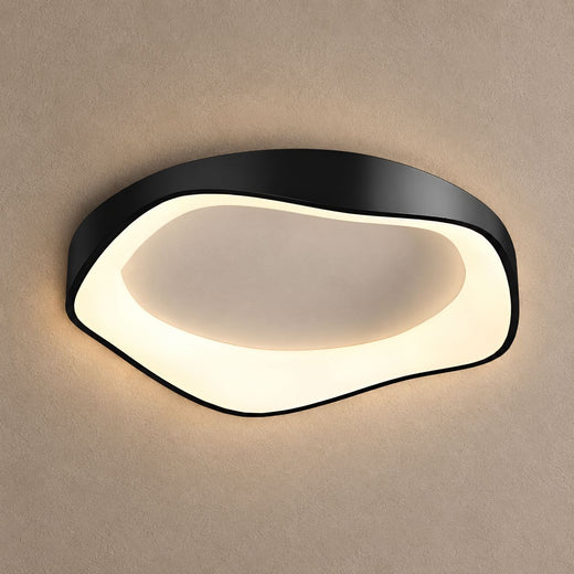 FLAIR black ceiling light with a soft irregular rounded shape and white diffuser, lit