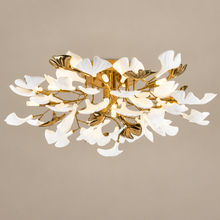 GINKORA gold and white ceramic ginkgo ceiling light on a mushroom taupe background