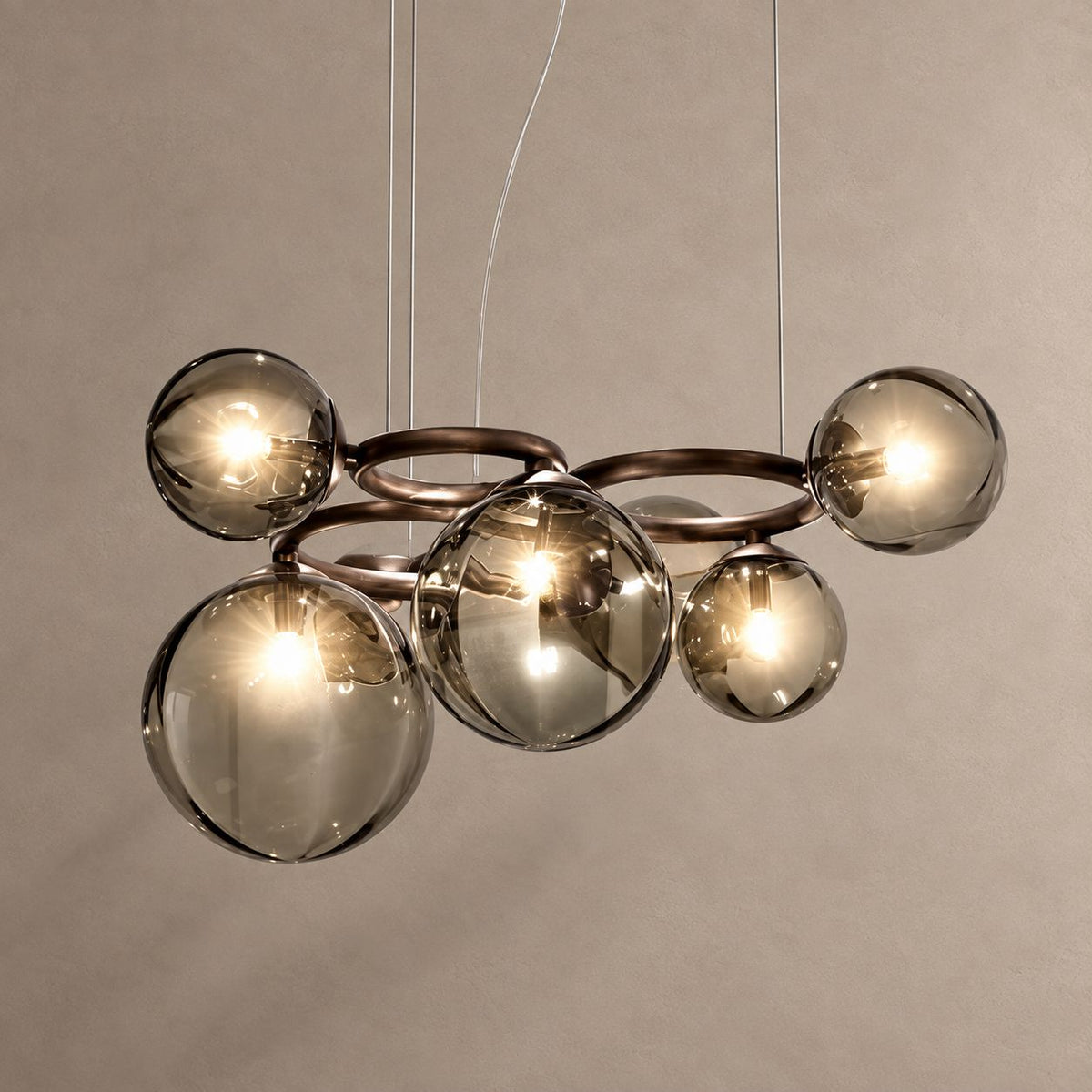 GLOBIQUE bronze chandelier with smoky glass globes on mushroom taupe plaster