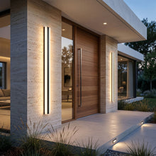 Lifestyle hero image of luxury villa entrance with Bolt wall light casting warm glow, emphasizing modern architecture and elegant design.