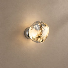 LAVA WALL clear molten-look acrylic orb wall lamp on a chrome-finish base, lit