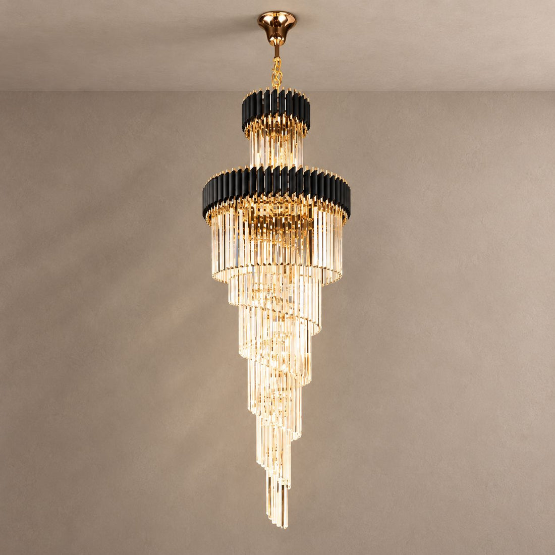 LIKANA black and gold spiral crystal chandelier against mushroom taupe plaster with natural ceiling shadows
