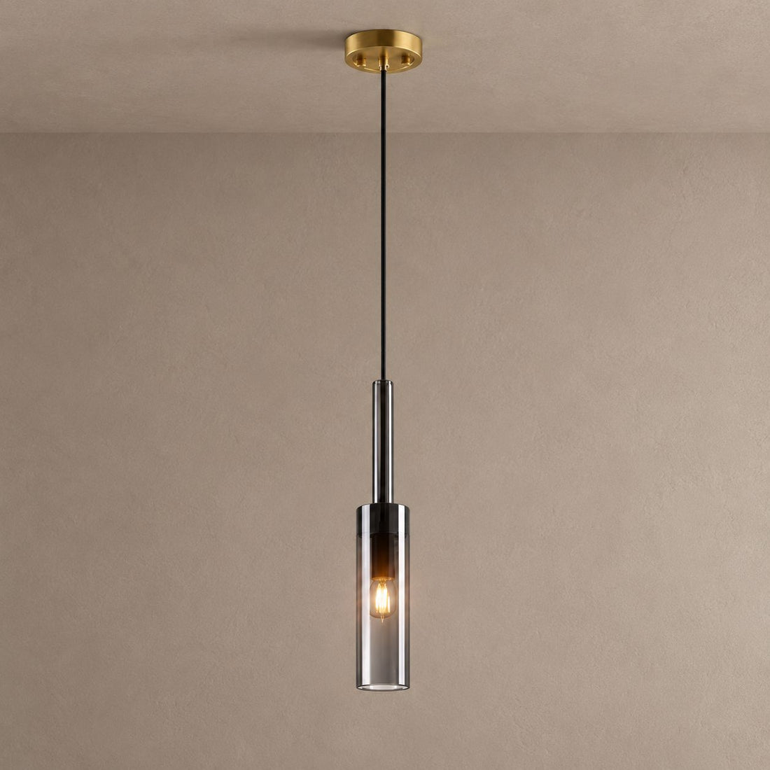 LYRA single smoked glass cylinder pendant with a brass ceiling canopy against mushroom taupe plaster