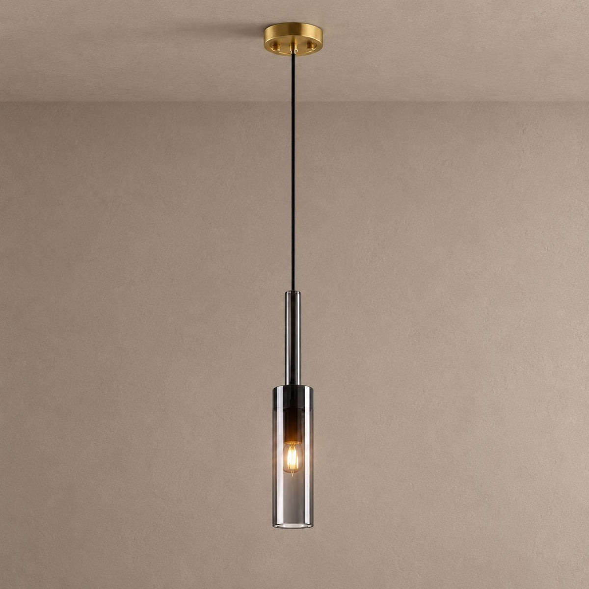 LYRA single smoked glass cylinder pendant with a brass ceiling canopy against mushroom taupe plaster