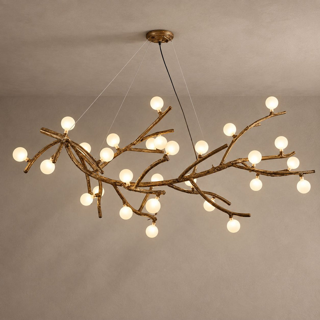 MIRA bronze branch chandelier with frosted globe bulbs on mushroom taupe plaster