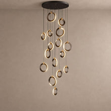 NEBULA polished ring cascade chandelier on mushroom taupe plaster with natural ceiling shadows