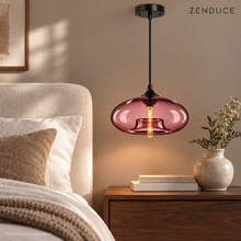 Wine Red NELIA glass pendant beside a bed in a warm neutral bedroom, illustrative visualization