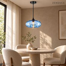 Light Blue NELIA glass pendant above a round dining table, illustrative visualization