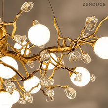 Close-up of NESSA textured Gold copper branches, irregular clear crystal buds and white globe shades