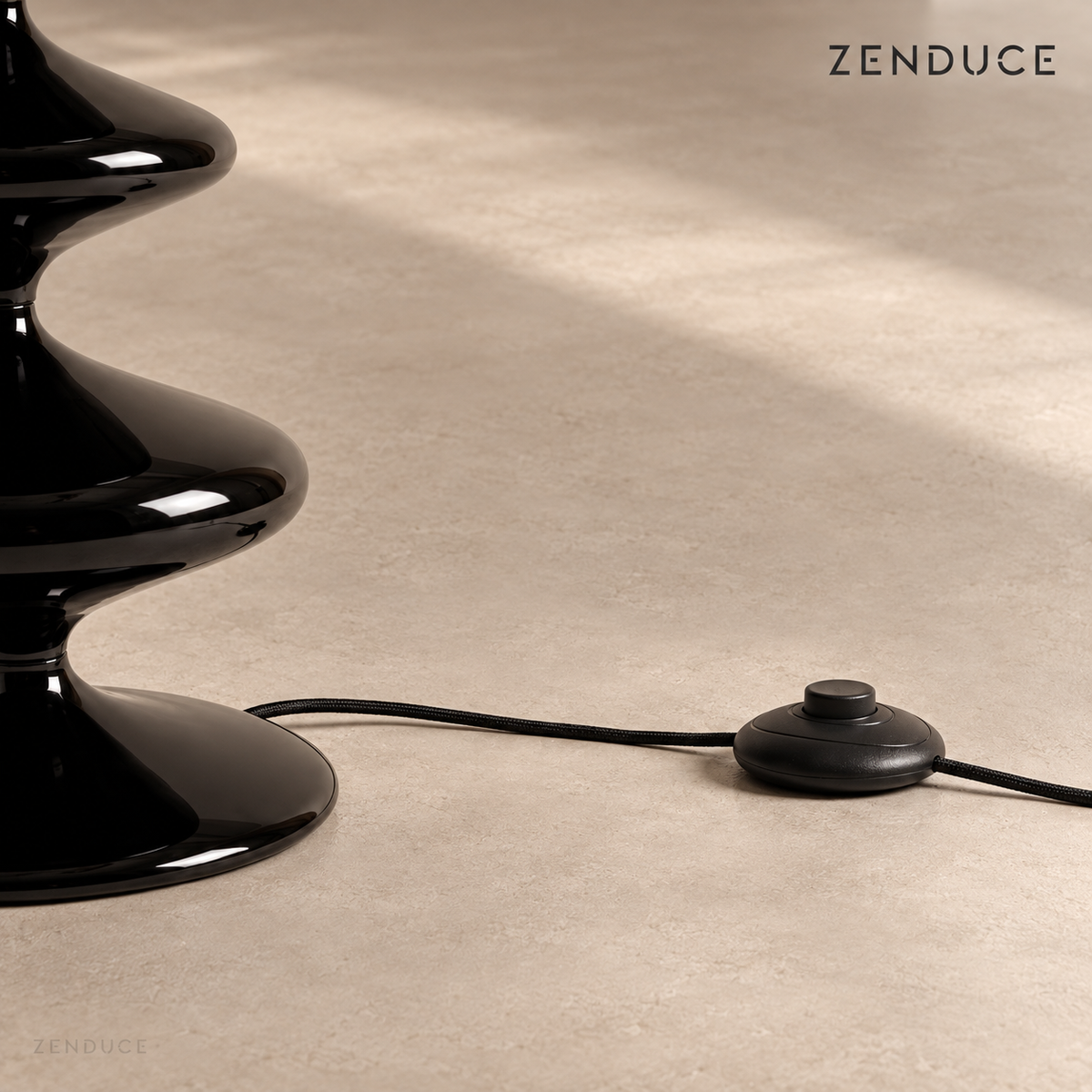 NOLIA black lamp base, cord, and round inline foot switch on a warm taupe floor