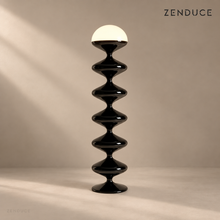 NOLIA black floor lamp with five rounded body sections and a warm glowing dome