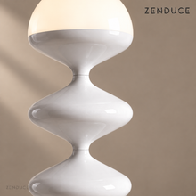 Close-up of NOLIA white gloss metal curves, narrow joins, and warm illuminated dome
