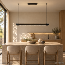 NOXVARE glossy black LED pendant with twin suspension wires over a taupe stone kitchen island