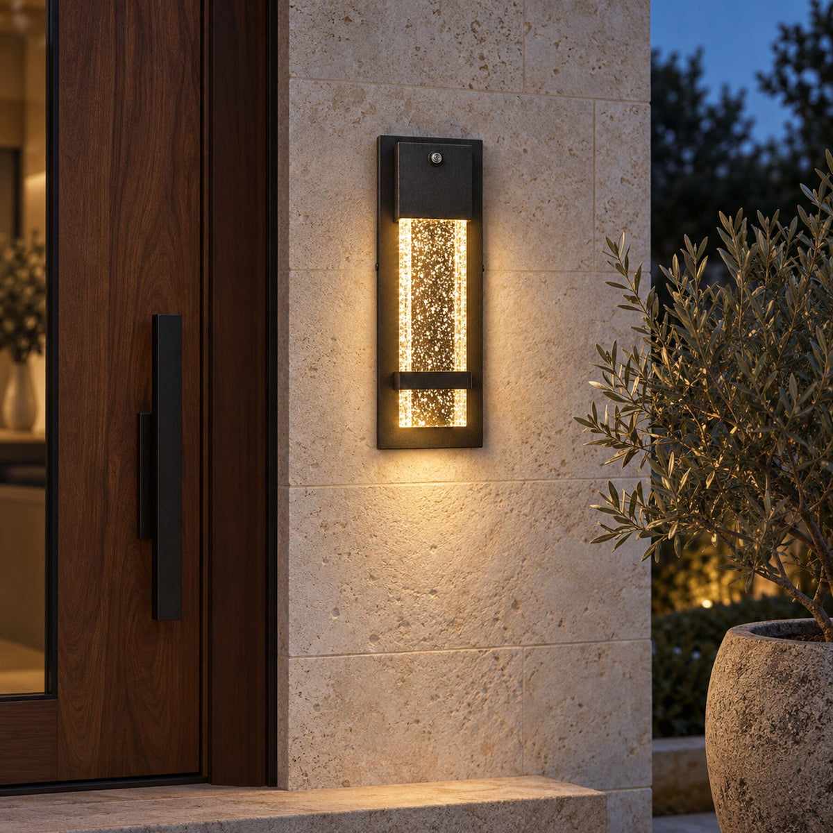 NUVIEL Dusk to Dawn Sensor wall light installed beside a walnut door and limestone wall, with warm evening illumination.