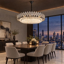 OMBRIA Large black crystal chandelier over formal dining table at dusk