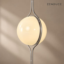 Close view of ORELIA acrylic globe and curved twin-rod chrome frame