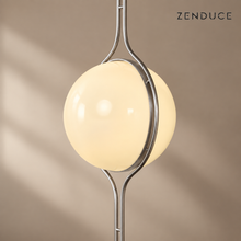 Close view of ORELIA acrylic globe and curved twin-rod chrome frame