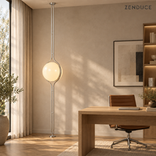 ORELIA Silver lamp next to an oak desk in a naturally lit home office