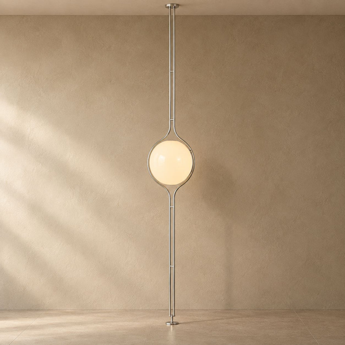 ORELIA silver floor-to-ceiling lamp with a warm acrylic globe and natural shadows
