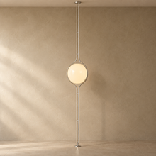 ORELIA silver floor-to-ceiling lamp with a warm acrylic globe and natural shadows