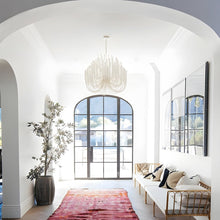 CERYNE - White wood chandelier in a bright arched entryway