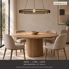 ORRIS 1 Ring - Large, black with gold accents, above an oak dining table in a neutral room. Illustrative arrangement; ring diameters 31.5″ (80 cm).