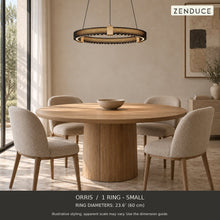 ORRIS 1 Ring - Small, black with gold accents, above an oak dining table in a neutral room. Illustrative arrangement; ring diameters 23.6″ (60 cm).