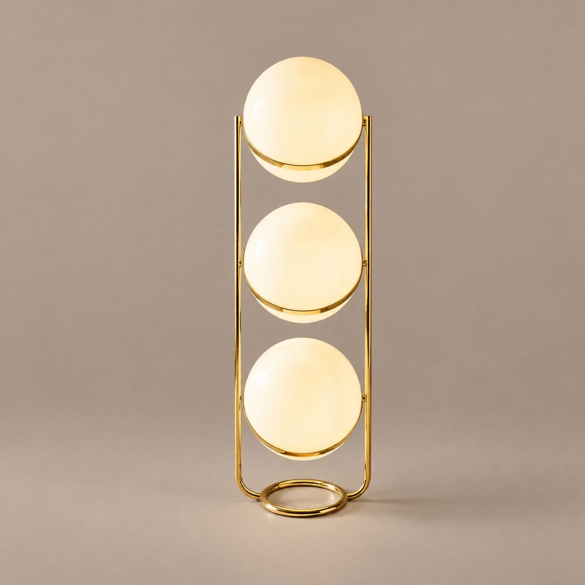 ORVENA three-tier brass globe floor lamp on a mushroom taupe background