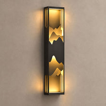 PARADISO tall dark outdoor wall lantern with layered mountain silhouettes and warm light on mushroom taupe