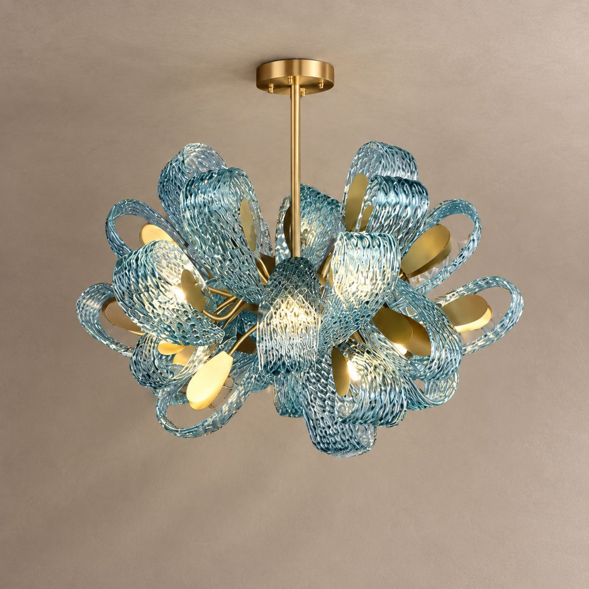 PAVO living room chandelier with teal textured glass leaves and brass fittings on mushroom taupe plaster