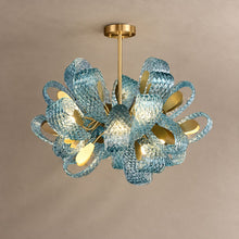 PAVO living room chandelier with teal textured glass leaves and brass fittings on mushroom taupe plaster