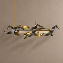 PRESTIGE black and gold sculptural ribbon chandelier on mushroom taupe plaster