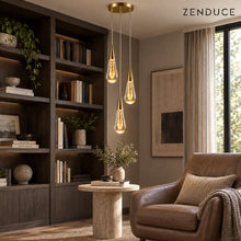 RAIN DROPS 3-light round gold chandelier beside a leather reading chair in a dark oak home library; photorealistic installation visualization.