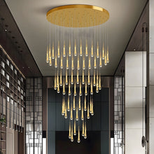 RAIN DROPS large round gold canopy and cascading crystal arrangement in a tall entry interior.
