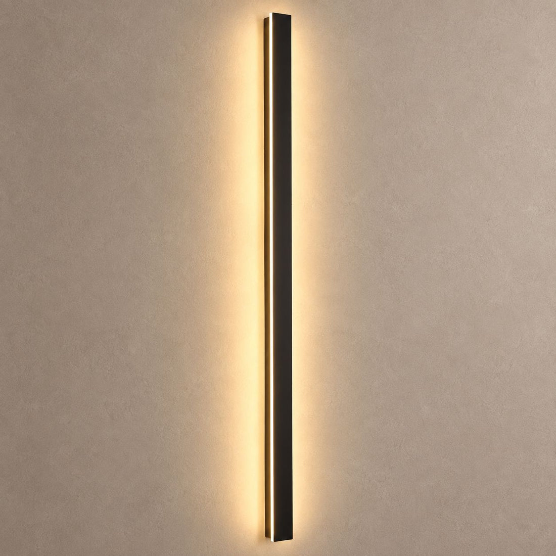 RAYN slim black wall light mounted on mushroom taupe plaster with warm backlight and natural shadows