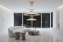 CIRCA triple-tier chandelier in a modern living room at night
