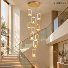 SELYA Gold crystal chandelier in an illustrative double-height staircase