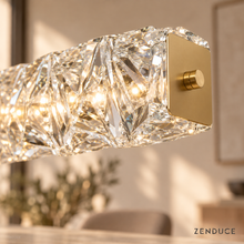 SEVRAYA close-up of clear faceted crystal and brushed gold end plate with cylindrical bolt