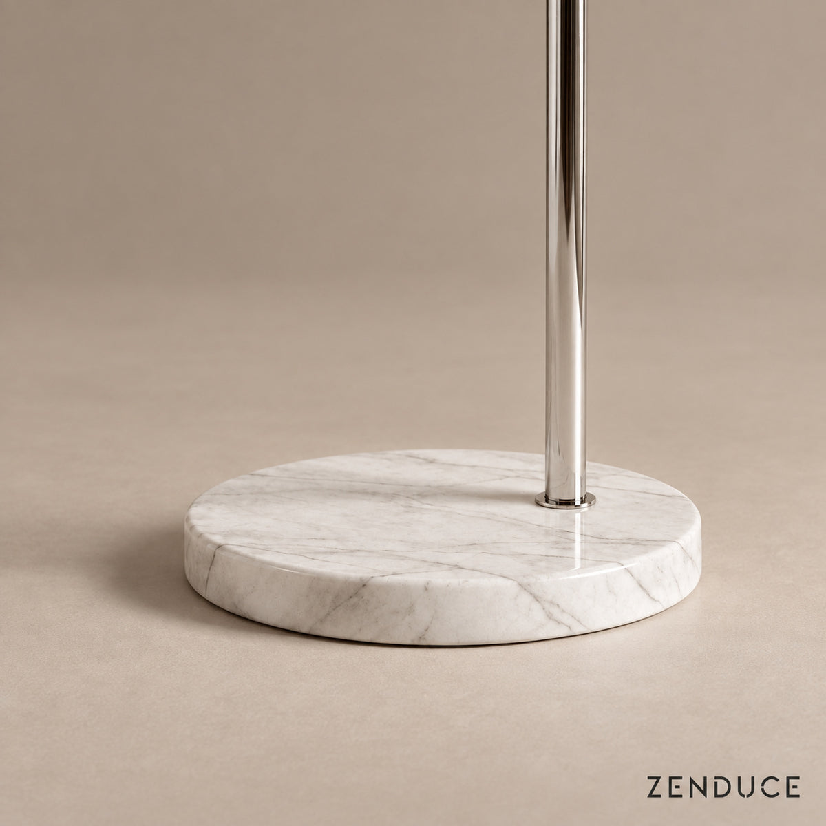 Close-up of SILENNA circular white marble base and offset polished steel stem