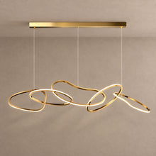 SOLARA gold chandelier with five interlinked organic LED loops against mushroom taupe plaster