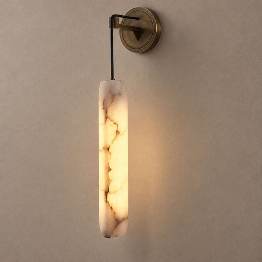 SOLUNA bronze wall sconce with glowing cylindrical marble shade on mushroom taupe plaster