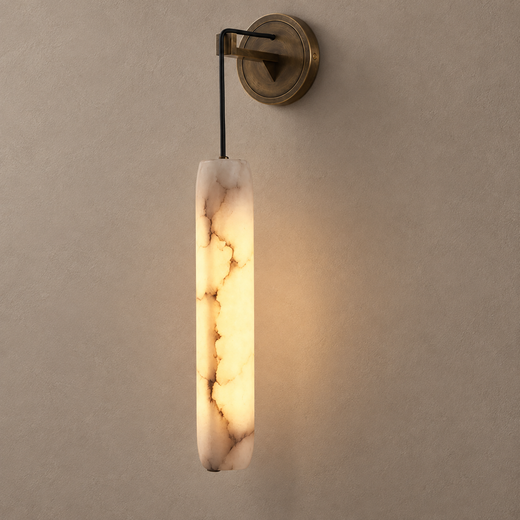 SOLUNA bronze wall sconce with glowing cylindrical marble shade on mushroom taupe plaster