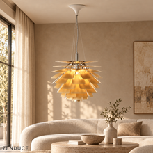 SYLUNE gold overlapping petal pendant suspended above a pale stone coffee table in a cream lounge