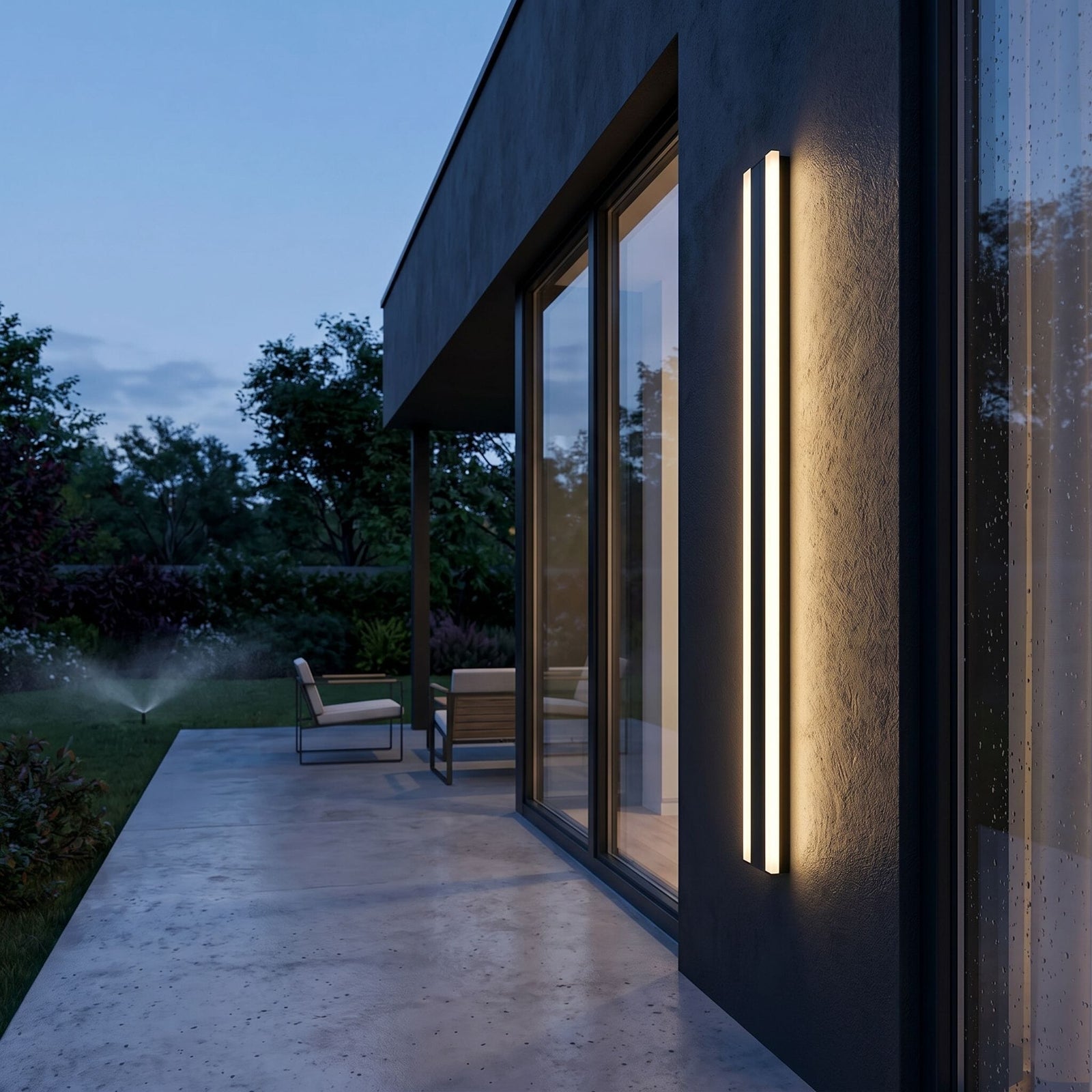 Wide-angle view of Bolt wall light on a modern house during twilight, highlighting sleek design and warm lighting effects.