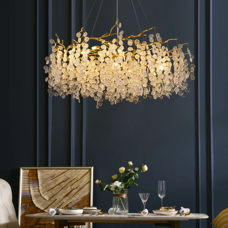 VALORA wide branch chandelier, lit, over a set dining table with navy drapes