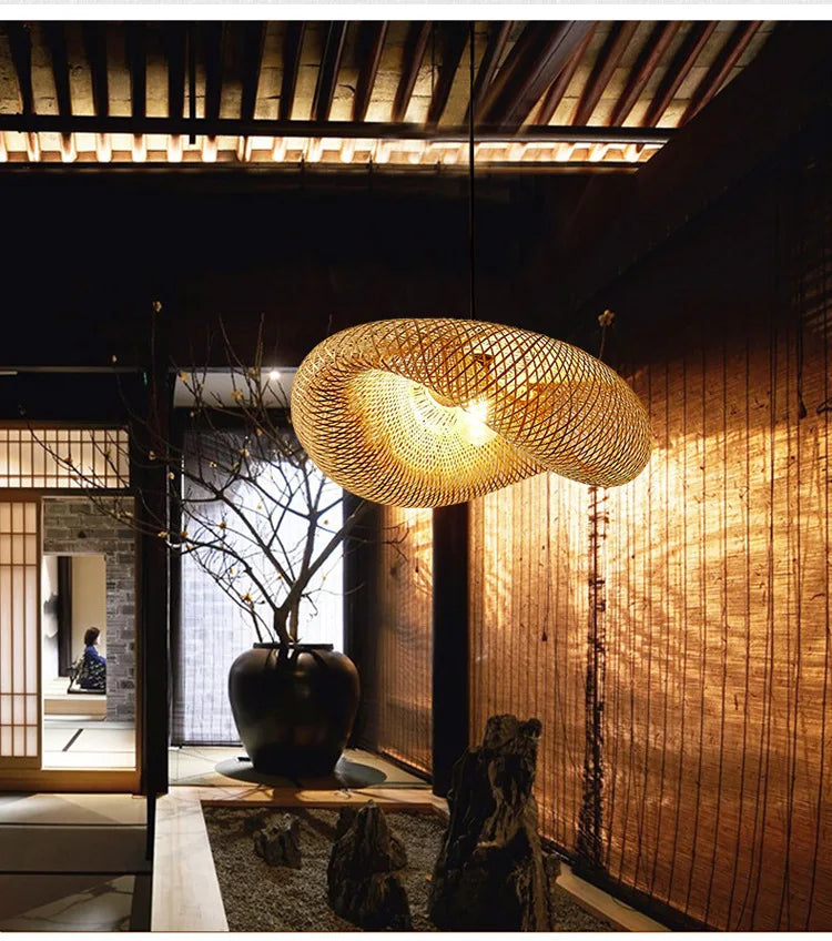BASK oval bamboo pendant, lit, in a Japanese-style room with a courtyard view