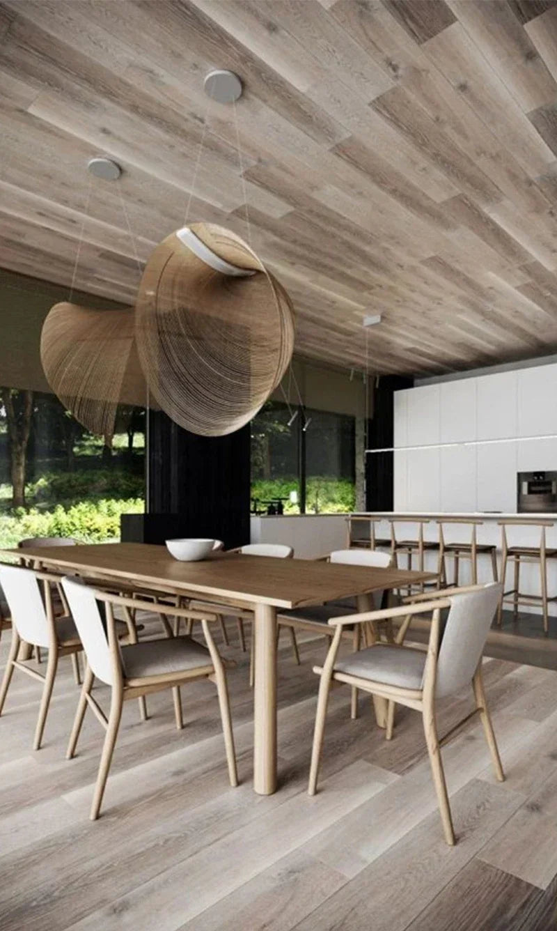 LUCORA large wood-strip pendants above a wooden dining table under a wood ceiling